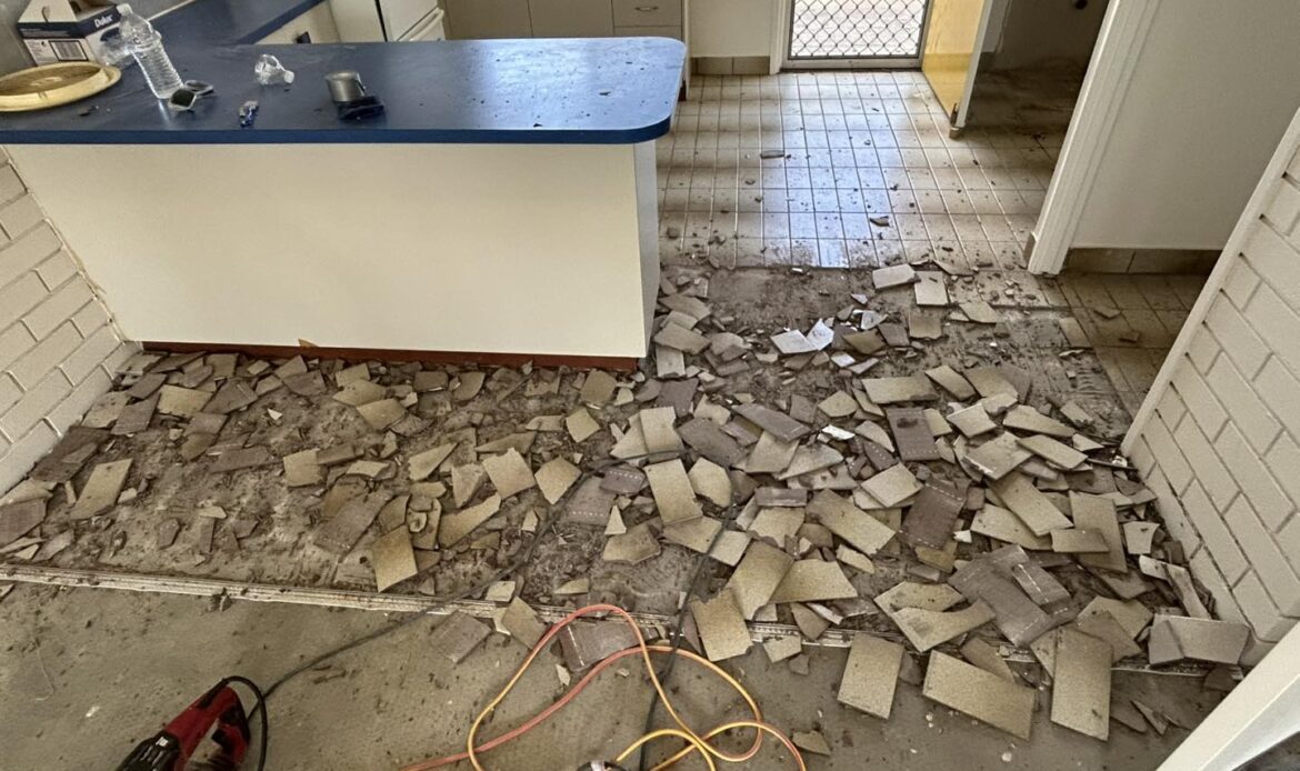 Broken tile floor ready for removal