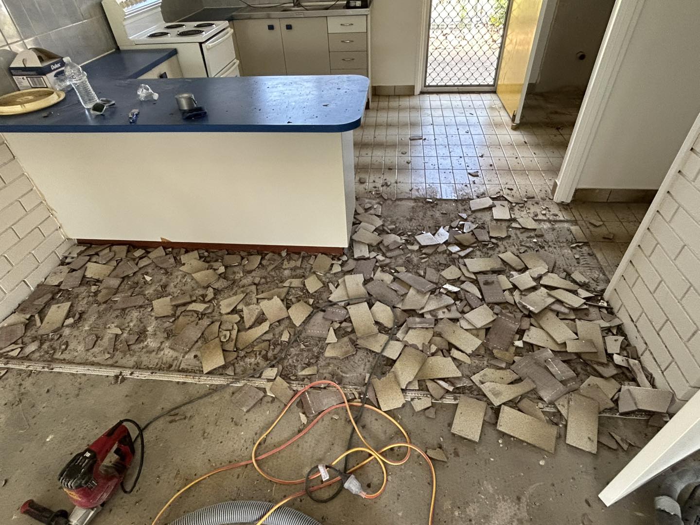 Broken tile floor ready for removal