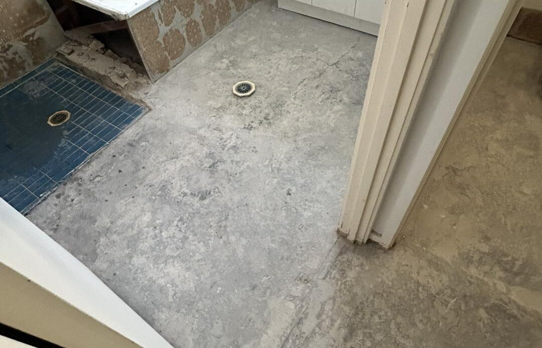 Bathroom floor stripped for waterproofing ready for subfloor installation